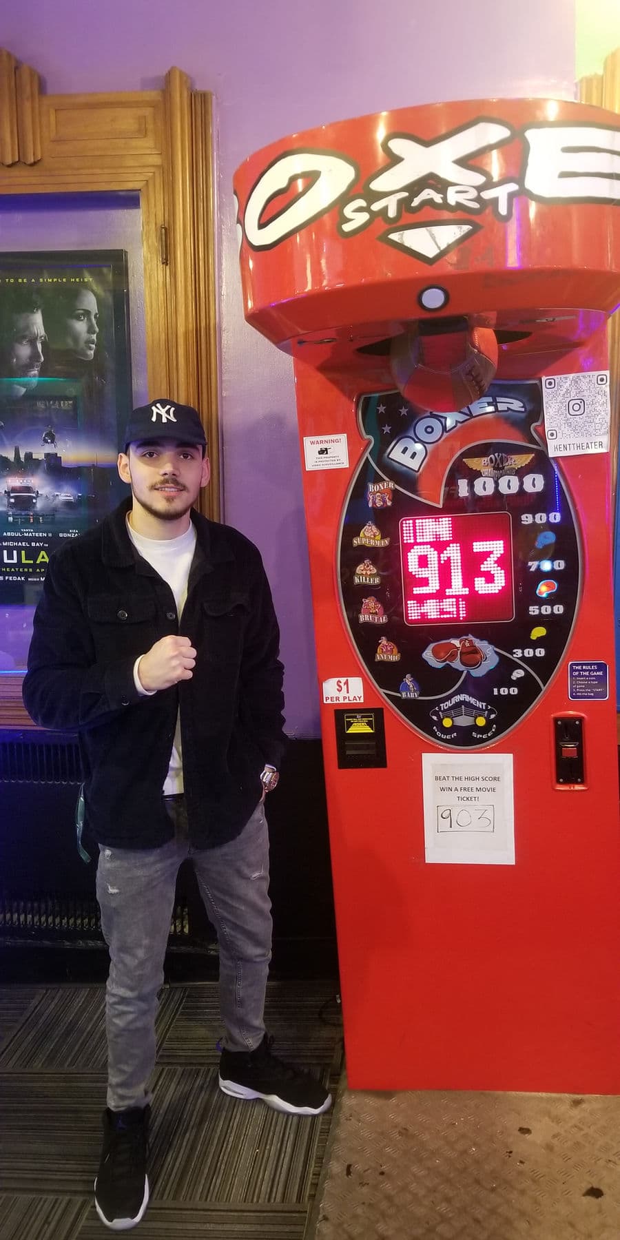 High score holder standing beside the Boxer arcade machine